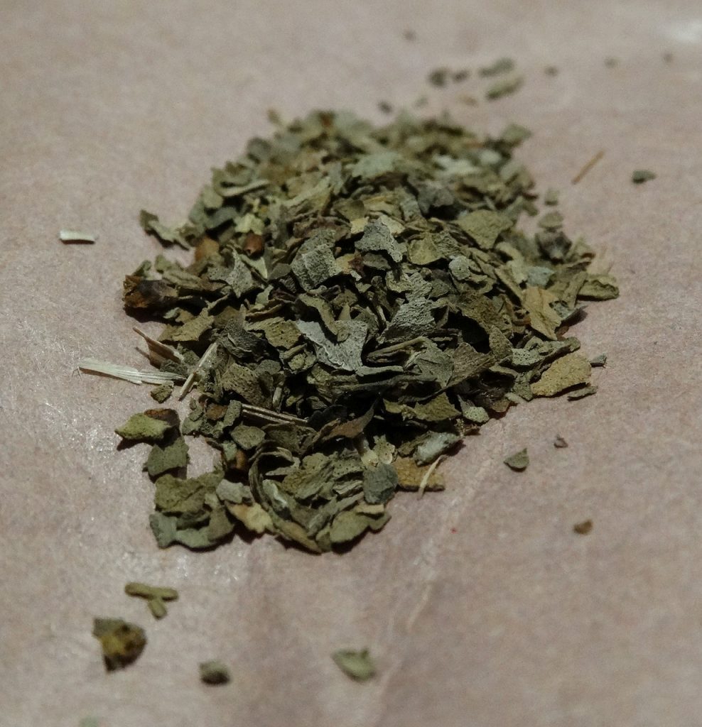 Dried basil leaves in a pile