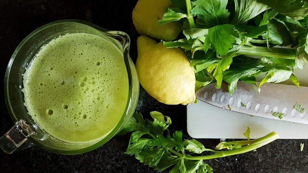 Celery Smoothie and cut up celery with lemons 